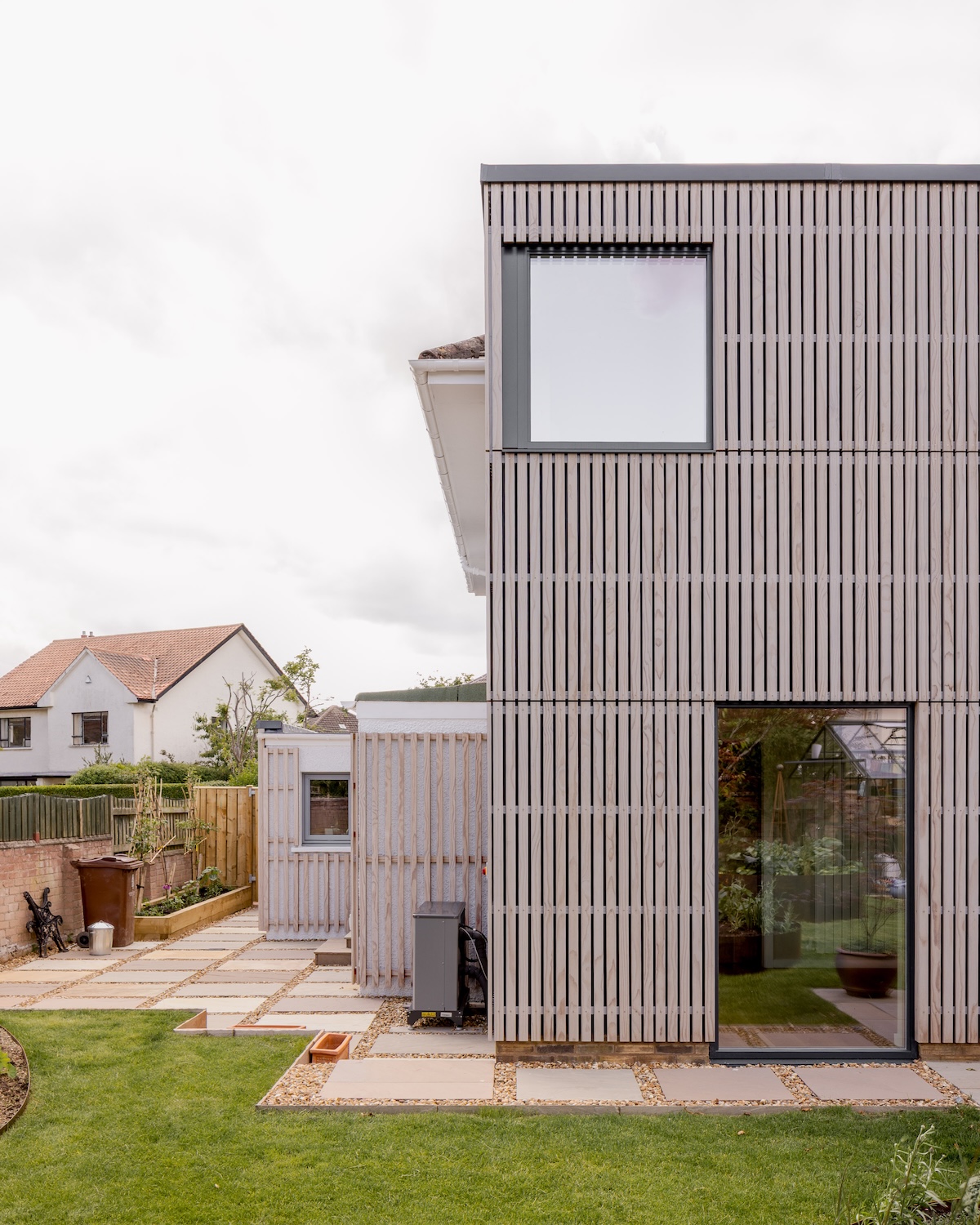 Part rear elevation. Deep retrofit and timber-clad two-storey extension to a Bonaly home by Calum Duncan Architects, using natural materials and vapour-open construction for healthy, sustainable living.